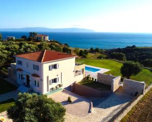 an external view of a villa with a view of the ocean at Villa Darymine in Skala Kefalonias