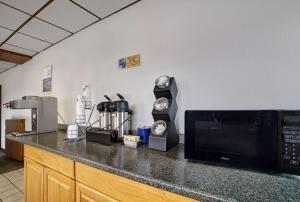 a kitchen with a counter with a microwave on it at Motel 6 Washington, PA in Washington