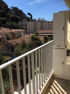 einen Balkon mit weißem Geländer und einige Gebäude in der Unterkunft Magnifique studio cœur de Nice in Nizza