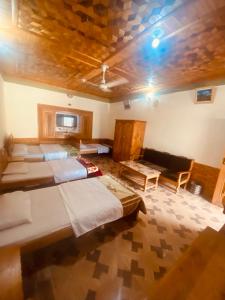 a large room with four beds and a couch at Taimoor Hotel swat Kalam in Kalām +16 photos