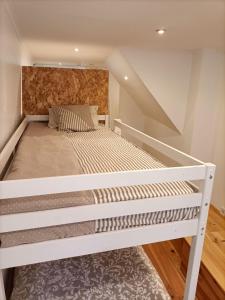 a large white bed in a room with stairs at NOW Bastidor Jovial in Lisbon