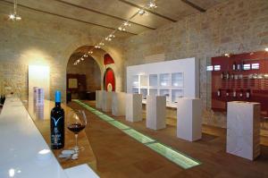a wine tasting room with a glass of wine on a counter at Holiday Homes Oliva in Bol