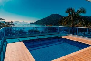 a swimming pool on the roof of a house with a view at Ubatuba Praia Hotel in Ubatuba