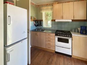 a kitchen with a white refrigerator and a stove at 4 person holiday home in VETLANDA in Vetlanda