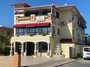 a building with a sign on the front of it at Grand Diamond Hotel Trinidad in Piarco