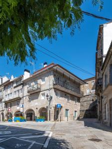 an old building on the corner of a street at Casa das Trabancas in Tui