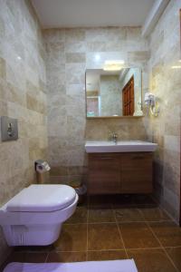 a bathroom with a toilet and a sink and a mirror at Dalya Life in Göcek