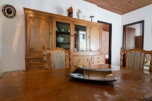 a dining room table with a large wooden cabinet at Apartment Kukljica 5 in Kukljica