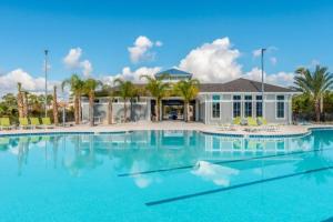 a large swimming pool in front of a house at Perdido Key Villa by the Sea in Perdido Key