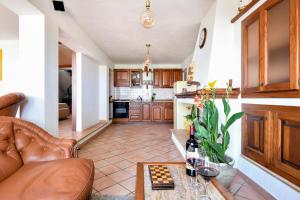 a living room with a couch and a table with wine bottles at Eleonora's Apartment in Santa Maria Navarrese