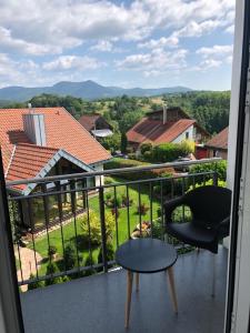 a chair and a table on a balcony with a view at FreiRaum in Annweiler am Trifels