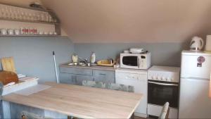 a kitchen with a table and a microwave at Apartment in Balatonmariafürdo 19297 in Hegy