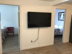 a flat screen tv hanging on a wall in a room at Windsor Motel in Lake George