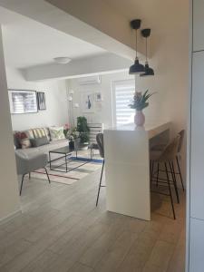 a kitchen and living room with a table and chairs at Apartment Central in Bajina Bašta