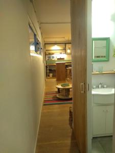 a hallway leading into a room with a sink at El Trotamundos in Puerto Pirámides