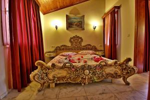an ornate bed in a bedroom with red curtains at Dalya Life in Göcek