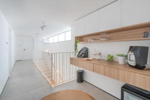 a room with a staircase with a tv and a shelf at Danielle boutique suite in Caesarea