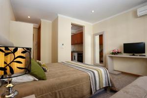 a bedroom with a bed and a tv on the wall at Oporto City Centre Apartments in Porto