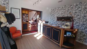 a kitchen with a counter and a chair in a room at Le Mas des Quintrands Manosque - Motel de charme in Manosque