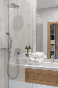 a bathroom with a tub, sink and mirror at CALVARY Hotel & Restaurant Vilnius in Vilnius