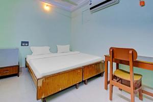 a bedroom with a bed and a desk and a chair at Decent residency in Kākināda