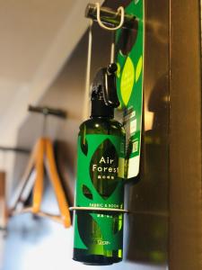 a green bottle of air forest mix sitting on a shelf at Ai Hotel Keikyu Kamata-ekimae in Tokyo