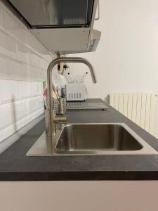 a sink in a kitchen with a tv above it at 1-Tourist House Bologna-Cefalonia - Self Check-in in Bologna