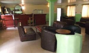 sala de estar con 2 sillas de cuero y mesa en Room in Apartment - Ade Super Hotel Single en Akure