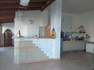 una cocina con isla en medio de una habitación en Room in BB - Quadruple room a stones throw from the sea - Ideal for a relaxing holiday, en Pineto