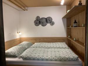 a bedroom with a bed and two butterflies on the wall at Apartmaji Taler in Bohinj