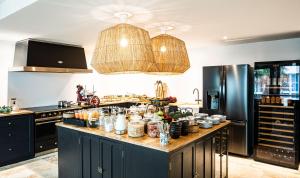a kitchen with a large counter with alot of food at Maisons du Monde Hôtel & Suites - La Rochelle Vieux Port in La Rochelle