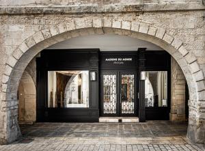 an entrance to a building with a black door at Maisons du Monde Hôtel & Suites - La Rochelle Vieux Port in La Rochelle