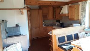 a small kitchen with wooden cabinets and a sink at Ferienwohnung Appesbacher in St. Wolfgang