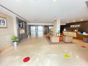 an office lobby with a reception desk and a lobby at Phoenix Plaza Hotel Apartments in Abu Dhabi