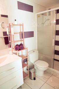 a bathroom with a toilet and a glass shower at Karin's Beach Loft, Playa del Cura in Playa del Cura