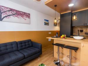 a living room with a couch and a kitchen at Cherry Friendly Holiday Home in Playa del Ingles