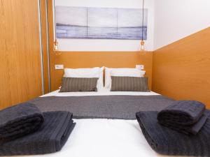 a bedroom with a bed with two pillows on it at Cherry Friendly Holiday Home in Playa del Ingles