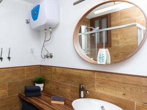 a bathroom with a round mirror and a sink at Cherry Friendly Holiday Home in Playa del Ingles +27 photos