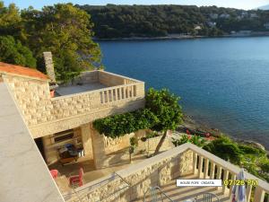 an aerial view of a house with a view of the water at Beachfront house Pope B&B in Selca +36 photos