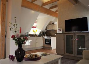 a kitchen with a vase of flowers on a table at Ferienwohnung Storchennest Spreewald in Burg Kauper