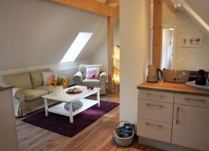 a living room with a couch and a table at Ferienwohnung Storchennest Spreewald in Burg Kauper