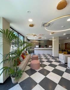 a lobby with a couch and a checkered floor at Soho Boutique Córdoba in Córdoba