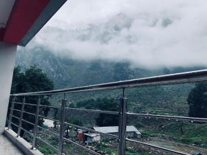 a view from a balcony of a mountain with clouds at Hotel Silver Oaks in Narān