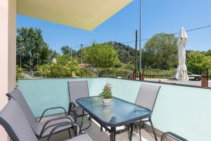 a table and chairs on a balcony with a view at Villa Laskaridis in Limenas