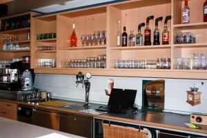 a bar with a laptop on top of a counter at Pension Seeblick Purbach in Purbach am Neusiedlersee