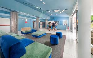 a waiting room at a hospital with blue furniture at Residence Poggio Dei Pini in Marina Romea