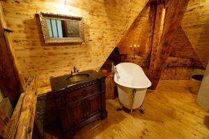 a bathroom with a sink and a tub in a cabin at Letohrádek sv. Vojtěch in Počátky