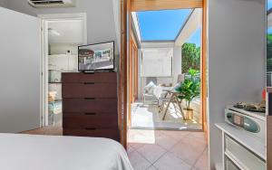a bedroom with a bed and a view of a patio at Residence Poggio Dei Pini in Marina Romea