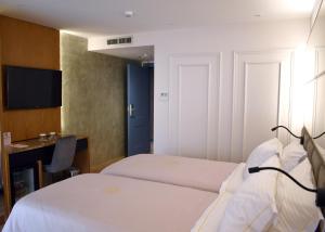 Postel nebo postele na pokoji v ubytování Giulia Albérgo Hotel