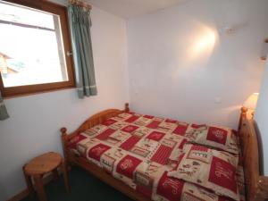 a bedroom with a bed with a christmas quilt at Appartement Les Saisies, 2 pièces, 4 personnes - FR-1-293-1 in Les Saisies